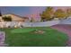 Backyard putting green with desert landscaping offers a fun and relaxing recreational space at 18103 W Canyon Ln, Goodyear, AZ 85338