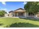 Backyard has lush turf, covered patio, and desert landscaping at 2453 E Nathan Way, Chandler, AZ 85225
