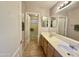 Well-lit bathroom featuring double sinks and vanity with tile floors at 2453 E Nathan Way, Chandler, AZ 85225
