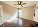 Bright bedroom with hardwood floors, ceiling fan, and natural light at 2453 E Nathan Way, Chandler, AZ 85225