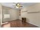 This bedroom has wood floors, a ceiling fan, modern window coverings, and built in floating shelves at 2453 E Nathan Way, Chandler, AZ 85225