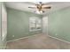 Bright bedroom with neutral carpet, a ceiling fan, and plantation shutters at 2453 E Nathan Way, Chandler, AZ 85225