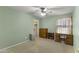 Comfortable bedroom with a ceiling fan, a small desk, and neutral walls at 2453 E Nathan Way, Chandler, AZ 85225