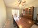 Inviting dining room with natural light, wood table and chairs, ceiling fan and hutch at 2453 E Nathan Way, Chandler, AZ 85225
