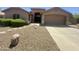 Attractive single-story home with well-maintained desert landscaping, two car garage and covered porch at 2453 E Nathan Way, Chandler, AZ 85225