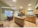 Well-lit kitchen with stainless appliances, tile floors, kitchen island, and breakfast nook at 2453 E Nathan Way, Chandler, AZ 85225