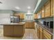 Well-lit kitchen with tiled floors, wood cabinets, and modern appliances at 2453 E Nathan Way, Chandler, AZ 85225