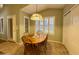 Cozy kitchen nook with wood table and chairs, pendant lighting, and ample natural light at 2453 E Nathan Way, Chandler, AZ 85225