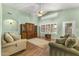 Spacious living room with high ceilings, wood floors, and a large window with plantation shutters at 2453 E Nathan Way, Chandler, AZ 85225
