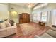 Bright living room boasts wood floors, high ceilings, large windows, ceiling fan and custom built-ins at 2453 E Nathan Way, Chandler, AZ 85225
