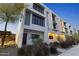 Modern townhome with crisp white exterior, red door, and manicured landscaping at 312 E Windsor Ave # 5, Phoenix, AZ 85004