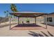 This backyard features a tiled gazebo, desert landscaping, and a block wall at 4621 E Mineral Rd, Phoenix, AZ 85044