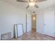 This bedroom has terracotta tile flooring, a ceiling fan, and two closets on either side of the door at 4621 E Mineral Rd, Phoenix, AZ 85044