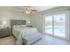 Bedroom with a ceiling fan and sliding door access to the pool area at 4621 E Mineral Rd, Phoenix, AZ 85044