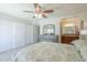 Spacious bedroom featuring a ceiling fan, large dresser and access to the bathroom at 4621 E Mineral Rd, Phoenix, AZ 85044