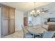 Inviting dining area with a decorative light fixture and a view into the living room at 4621 E Mineral Rd, Phoenix, AZ 85044