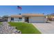 Charming single-story home featuring an American flag, rock landscaping, and a well-maintained lawn at 4621 E Mineral Rd, Phoenix, AZ 85044