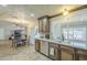 Bright kitchen with a stainless steel dishwasher, a kitchen window and dining area at 4621 E Mineral Rd, Phoenix, AZ 85044