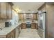Spacious kitchen features stainless steel appliances, granite counters and tile floors at 4621 E Mineral Rd, Phoenix, AZ 85044