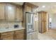 Kitchen featuring stainless steel refrigerator, custom cabinets, and granite countertops at 4621 E Mineral Rd, Phoenix, AZ 85044