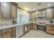 Well-lit kitchen featuring stainless steel appliances, granite counters and backsplash at 4621 E Mineral Rd, Phoenix, AZ 85044