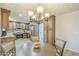 Eat in kitchen with dark wood cabinets, stainless steel appliances, and tiled backsplash at 4621 E Mineral Rd, Phoenix, AZ 85044