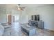 Bright living room with ample seating, tiled floor, and an open entryway at 4621 E Mineral Rd, Phoenix, AZ 85044