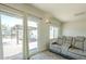 This living room has a view of the backyard, a reclining sofa, and access to the backyard patio at 4621 E Mineral Rd, Phoenix, AZ 85044