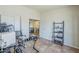 Office area with tile flooring, a sliding door and a view into another room at 4621 E Mineral Rd, Phoenix, AZ 85044