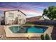 Inviting backyard with a sparkling pool, patio seating, and lush landscaping at 567 E Bradstock Way, Queen Creek, AZ 85140