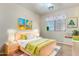 Cozy bedroom designed with vibrant artwork, soft lighting, and playful decor elements at 567 E Bradstock Way, Queen Creek, AZ 85140