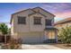 Charming two-story home with a two car garage and neutral colored stucco in a residential neighborhood at 567 E Bradstock Way, Queen Creek, AZ 85140