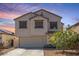 Charming two-story home with a two car garage and neutral colored stucco in a residential neighborhood at 567 E Bradstock Way, Queen Creek, AZ 85140