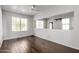 Bright living room with hardwood floors, large windows, and a mirrored wall at 567 E Bradstock Way, Queen Creek, AZ 85140