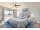 Beautiful main bedroom with a ceiling fan, balcony access, and stylish furnishings at 567 E Bradstock Way, Queen Creek, AZ 85140