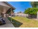 Spacious backyard with lush green grass and covered patio for outdoor relaxation at 6110 E Ivyglen St, Mesa, AZ 85205