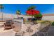 Outdoor kitchen and dining area with comfortable seating perfect for backyard entertaining at 6110 E Ivyglen St, Mesa, AZ 85205