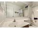 Well-lit bathroom featuring a sink, vanity, and shower with framed mirror at 6110 E Ivyglen St, Mesa, AZ 85205