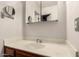 Bathroom with white marble countertop, modern sink, and mirrored vanity at 6110 E Ivyglen St, Mesa, AZ 85205