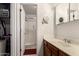 Bathroom featuring a wood vanity, framed mirror and shower at 6110 E Ivyglen St, Mesa, AZ 85205