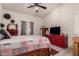 Well-lit bedroom features ceiling fan, tiled floors, and bright decor at 6110 E Ivyglen St, Mesa, AZ 85205