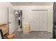 Bright bedroom features a closet and doorway to a light-filled living space with white tile flooring at 6110 E Ivyglen St, Mesa, AZ 85205