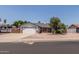 Inviting single-story home with a two-car garage and desert landscaping in the front yard at 6110 E Ivyglen St, Mesa, AZ 85205