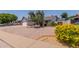 Charming front yard with desert landscaping, mature tree, and a view of the single story home at 6110 E Ivyglen St, Mesa, AZ 85205