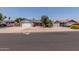 Cozy single-story home featuring a two-car garage, desert landscaping, and a brick-accented facade at 6110 E Ivyglen St, Mesa, AZ 85205