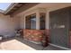 Cozy front porch featuring a small table with chairs and a secure front door at 6110 E Ivyglen St, Mesa, AZ 85205
