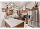 Modern kitchen with stainless steel appliances, wooden cabinets, and white countertops at 6110 E Ivyglen St, Mesa, AZ 85205