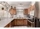 Bright kitchen featuring stainless steel appliances, oak cabinets, and lots of counter space at 6110 E Ivyglen St, Mesa, AZ 85205