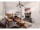 Vaulted ceiling living room features a stone fireplace, tile floors, and bright neutral paint at 6110 E Ivyglen St, Mesa, AZ 85205