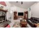 Open living space features tile floors, neutral paint, and a cozy atmosphere with a stone fireplace at 6110 E Ivyglen St, Mesa, AZ 85205